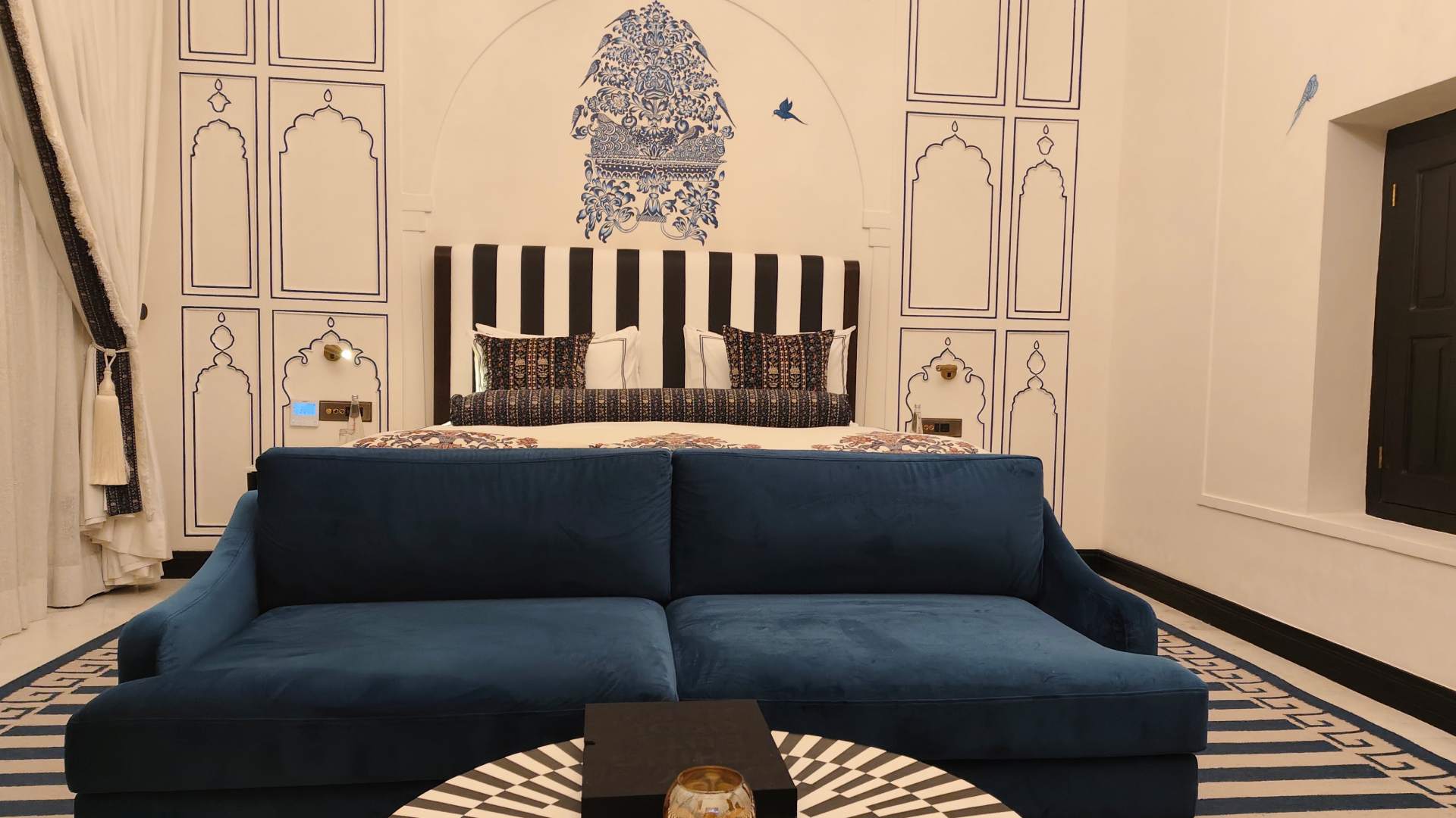 Bedside and bed bench wall art in the Junior Suite at Raan Bass The Palace
