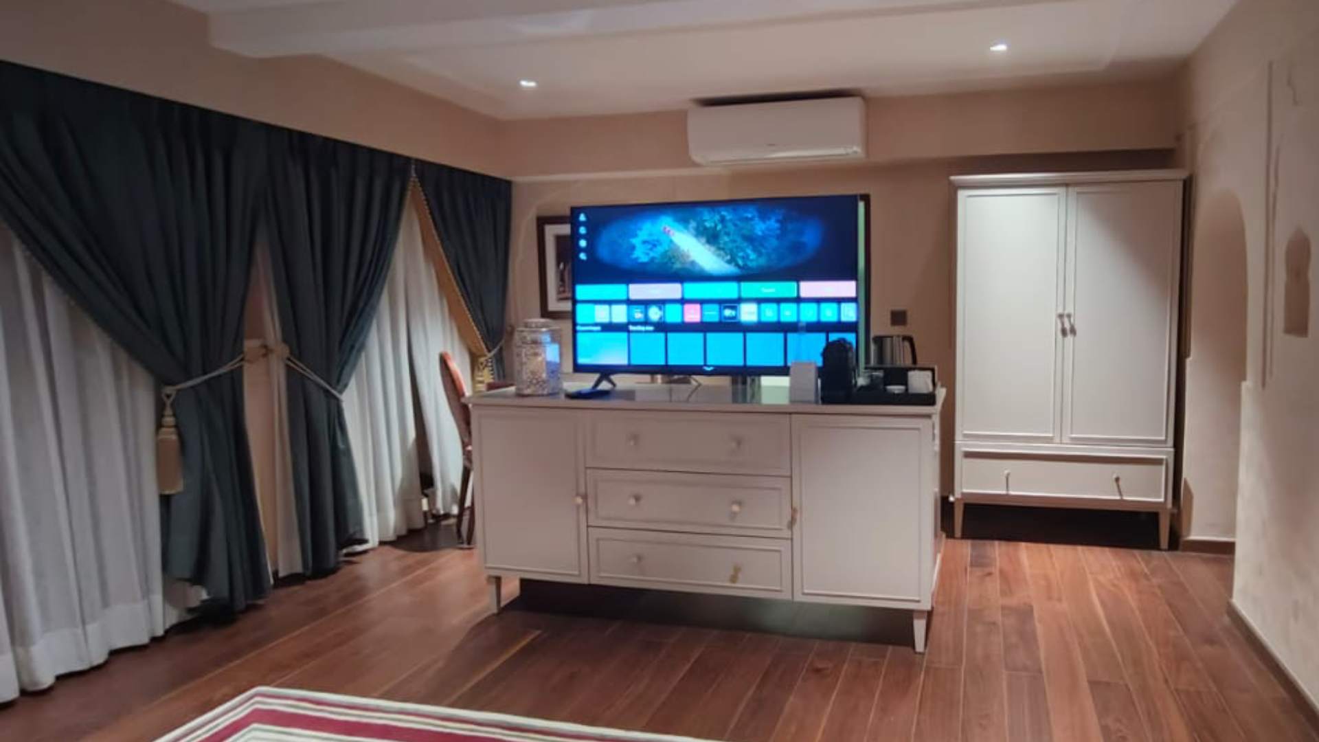 TV on a cabinet in the Legacy Suite at Raan Bass The Palace