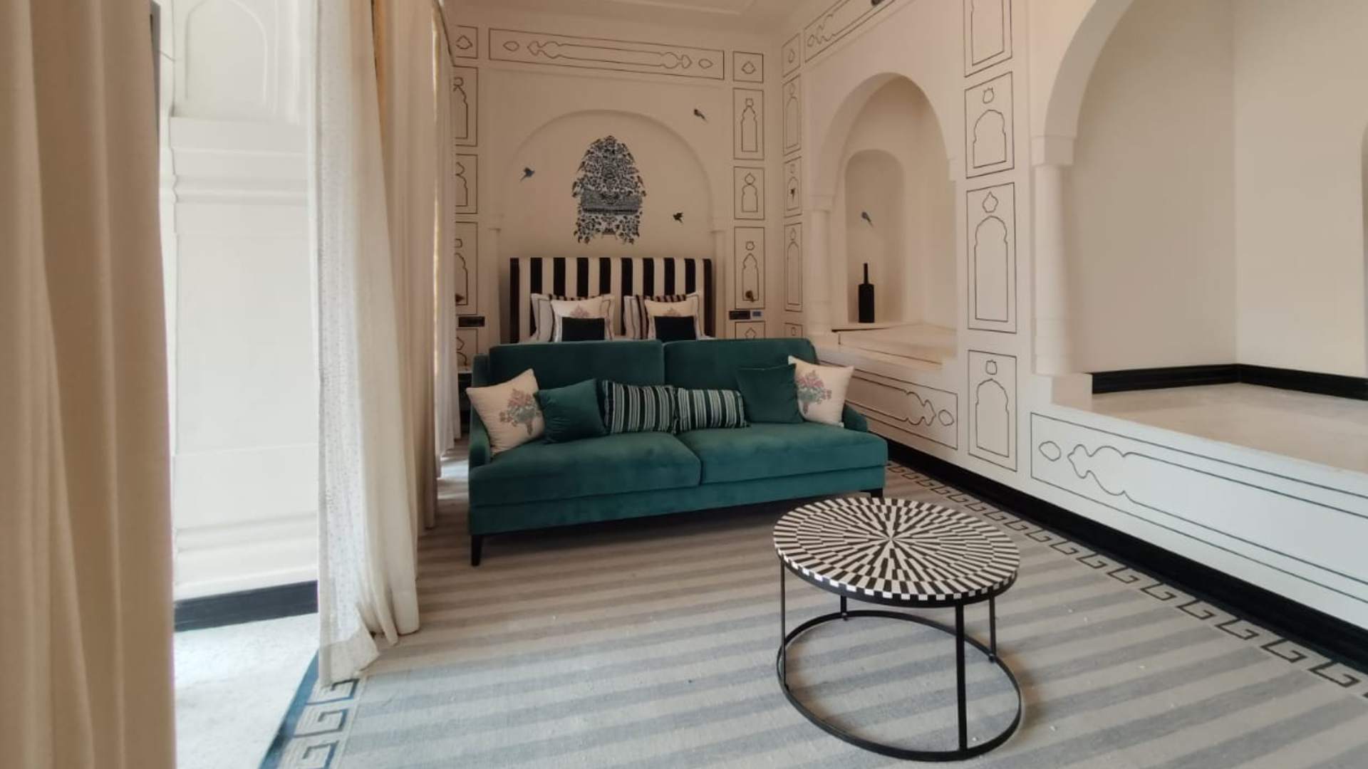 Bedside sofa and coffee table in the Legacy Suite at Raan Bass The Palace