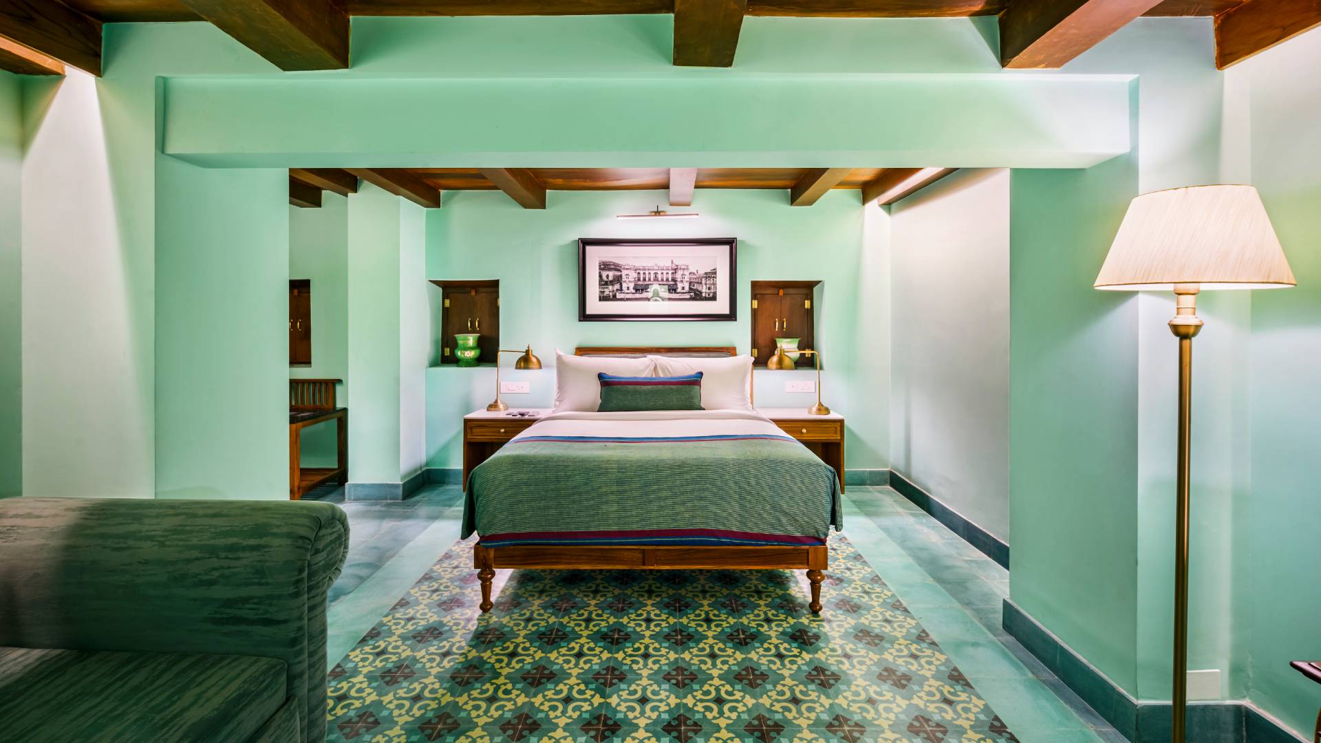 Double bed and antique lamp shades at Rani Suite in The Lotus Palace Chettinad